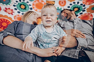 Family happy moments. summer vacation. hipster family playing with cute little son on hammock in summer sunny park. stylish mom