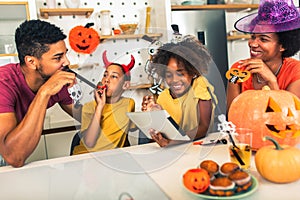 Family has fun in Halloween time make video call with digital tablet