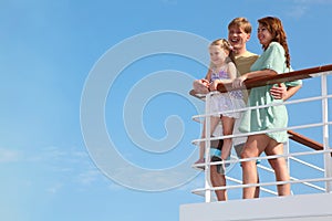 Family has leisure in cruise on motor ship photo