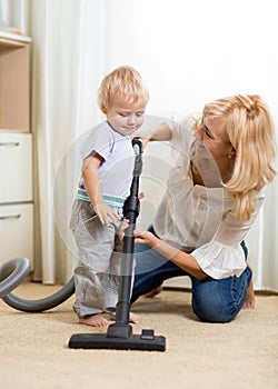 Family have fun with cleaning with hoover -