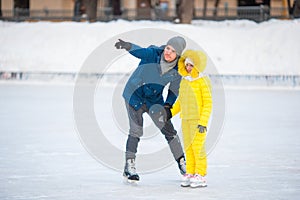 Family have fun on skating rink outdoors