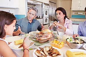 Family Having Argument Sitting Around Table Eating Meal