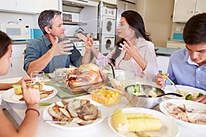 Family Having Argument Sitting Around Table Eating Meal