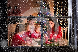 Family having Christmas dinner at fire place