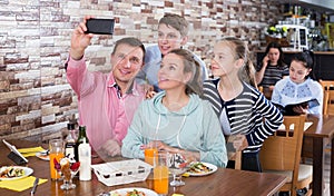 Family having dinner in cafe