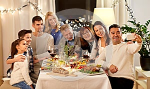 Family having dinner party and taking selfie