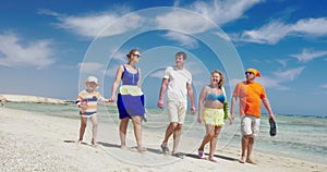 Family having enjoyable walk on the beach