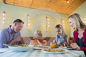 Family having food at restaurant