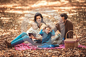 Family having fun in the autumn park.