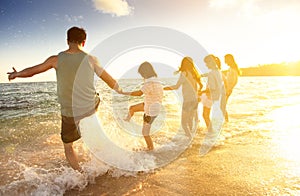 family having fun on the beach