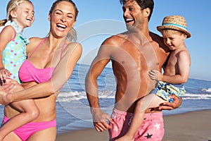 Family Having Fun On Beach