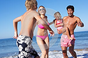 Family Having Fun On Beach