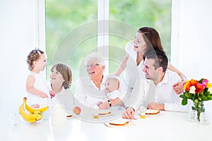 Family having fun at breakfast with grandmother