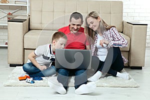 Family having fun chating on internet with laptop. Family having