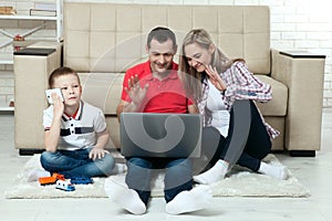 Family having fun chating on internet with laptop. Family having