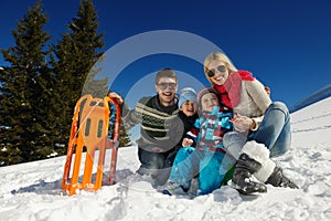 Family having fun on fresh snow at winter