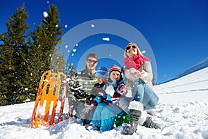 Family having fun on fresh snow at winter