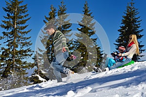 Family having fun on fresh snow at winter