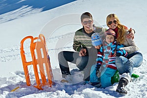 Family having fun on fresh snow at winter vacation