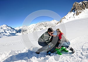 Family having fun on fresh snow at winter vacation