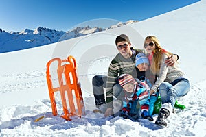 Family having fun on fresh snow at winter vacation