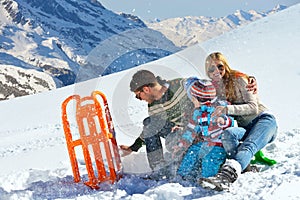 Family having fun on fresh snow at winter vacation