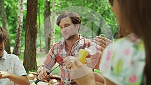 Family having fun in park together. Happy siblings playing with soap bubbles