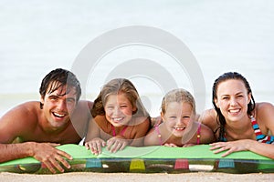 Family Having Fun In Sea On Airbed