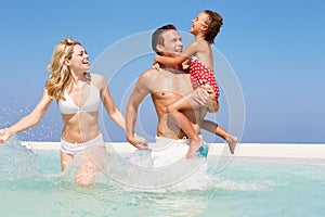 Family Having Fun In Sea On Beach Holiday