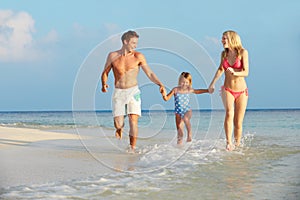 Family Having Fun In Sea On Beach Holiday