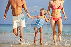 Family Having Fun In Sea On Beach Holiday