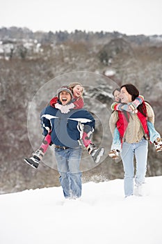 Family Having Fun In Snow