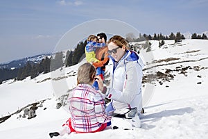 Family having fun in the snow photo