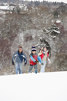 Family Having Fun In Snowy Countryside