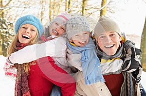 Family Having Fun Snowy Woodland