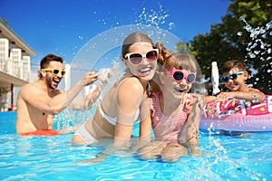 Family having fun in swimming pool