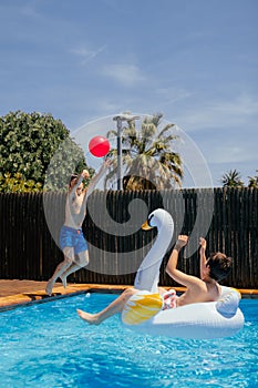 Family having fun in swimming pool