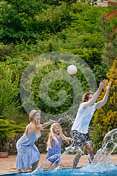 Family having fun their pool. family splashing water with legs or hands in swimming pool