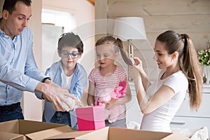 Family having fun unpacking on moving day to new house