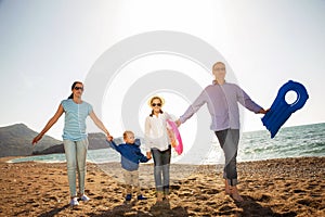 Family Having Fun Walking on Beach
