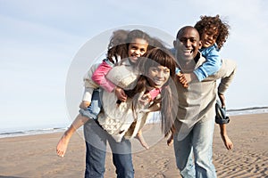 Family Having Fun On Winter Beach