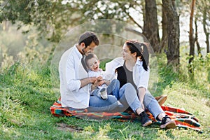 Family having a great time in the park. Father hugs son. Happy family on nature