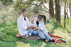 Family having a great time in the park. Father hugs son. Happy family on nature