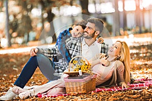 Family having picnic in autumn park