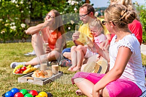 Family having picnic in garden front of their home