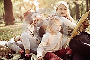 Family having picnic in park.