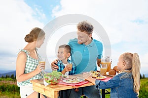 Family having picnic at table in park