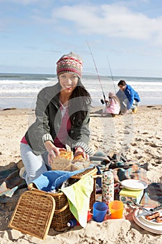 Family Having Picnic On Winter Beach