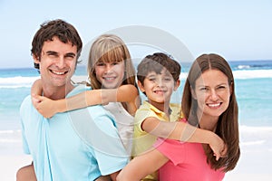 Family Having Piggyback On Beach photo