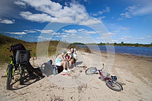 Family having a rest on a river coast